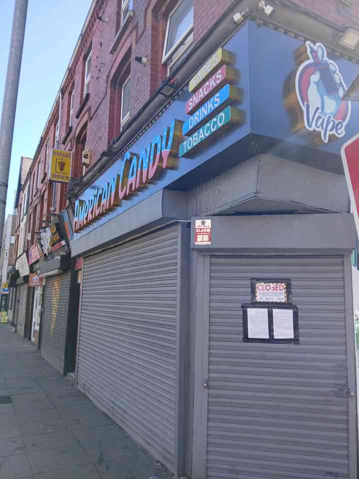 A shop front with a closure order on the shutters.