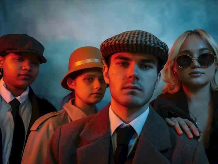 Four young people dressed in 1920s fashion