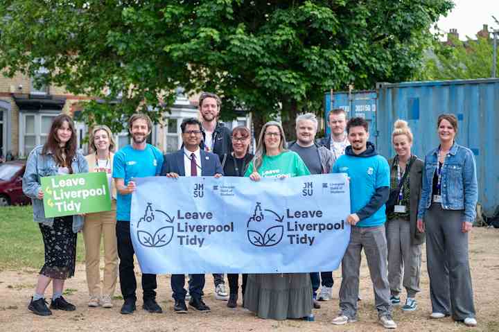 Members from the Guild of Students, Liverpool City Council, local Councillors and John Moores Students’ Union standing with a Leave Liverpool Tidy banner in front of a shipping container