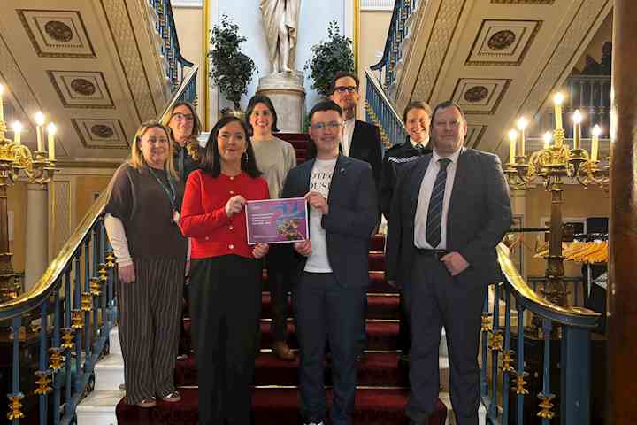 Group of people stood on the stairs in the Liverpool Town Hall.