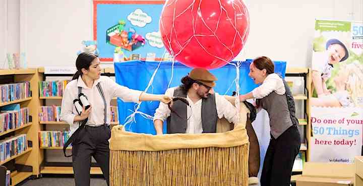 A man in a hot air balloon basket in a library