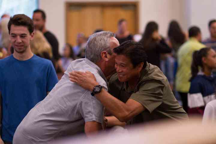Two men hugging