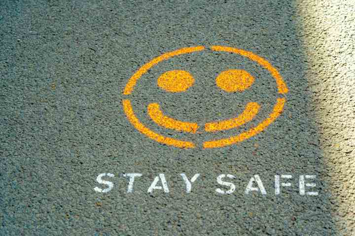 Yellow smiley face with text underneath that reads 'Stay Safe'