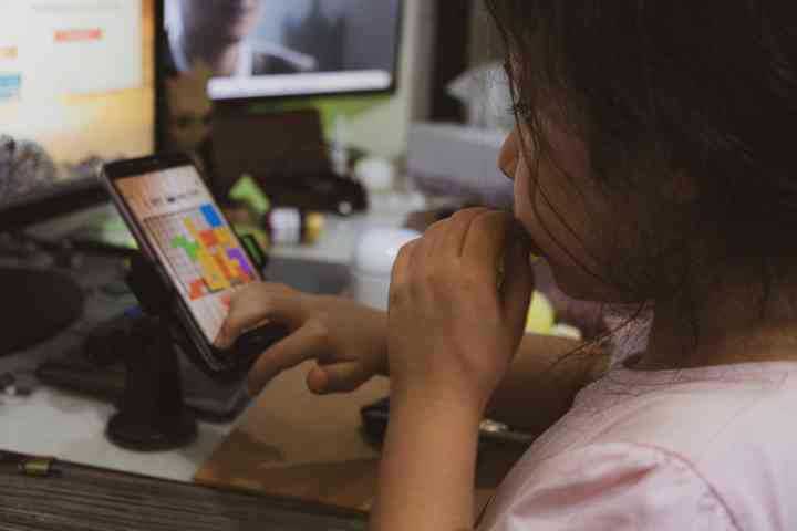 Young girl playing a game on their phone
