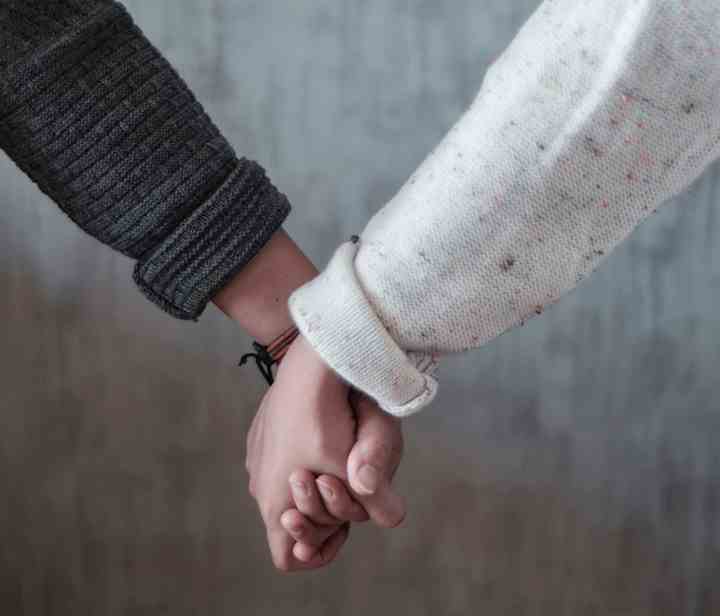 2 people holding hands